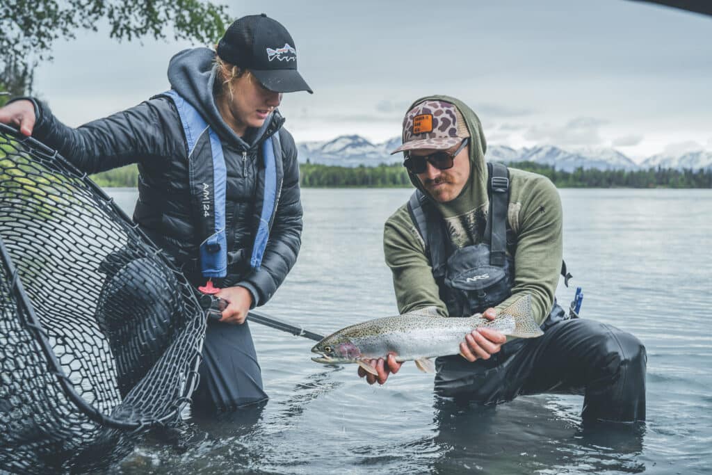 Guide posing with guest on the kenai river.
