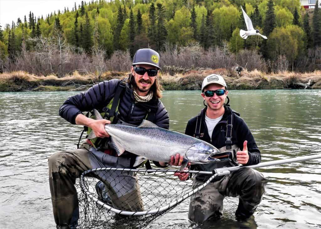 Guide and client holding a Kasilof River King Salmon On as May Fishing Trip