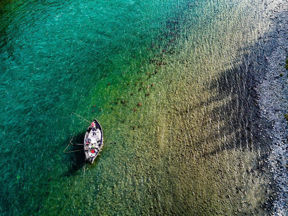 Boats fishing on the clear waters of Kenai River, Alaska.