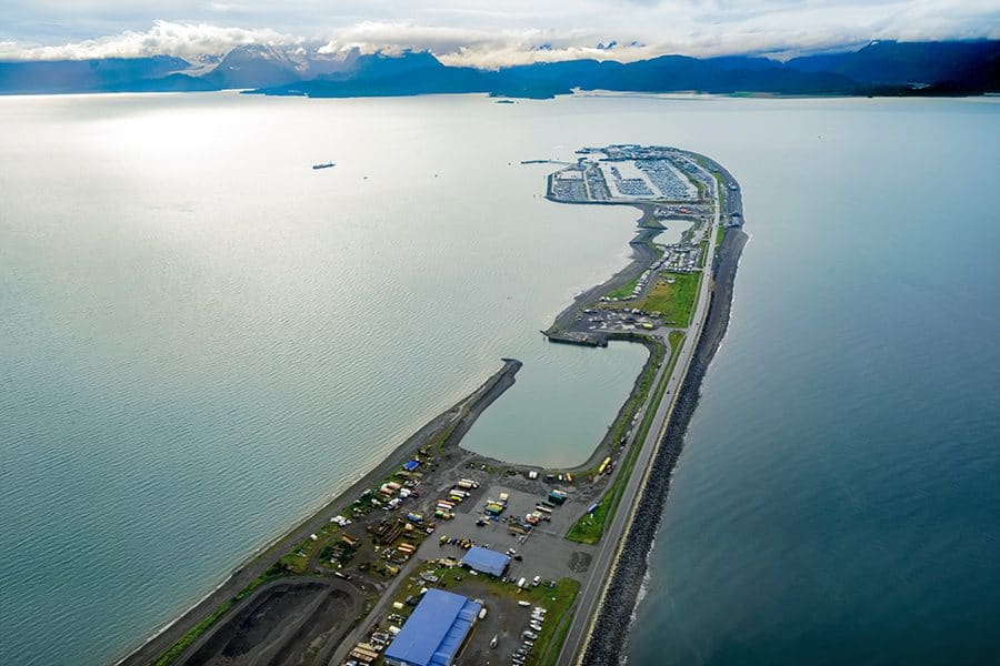 Aerial view of Kenai River Drifters Lodge with boats and scenic water views in Kenai, Alaska.