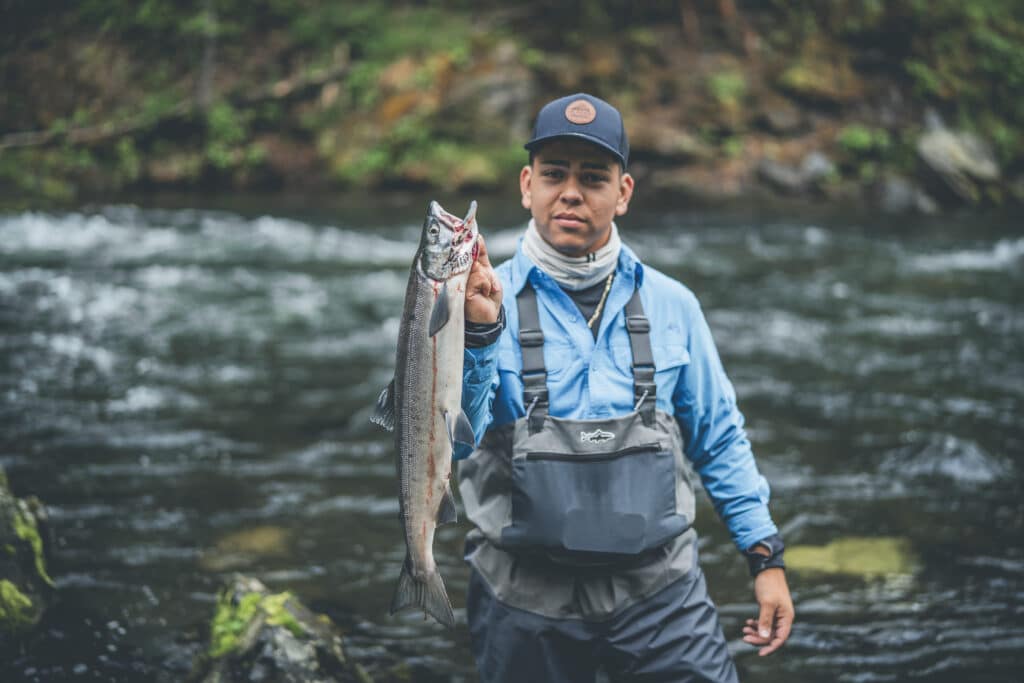 Fish caught by angler at Kenai River Drifters Lodge, Alaska, outdoor fishing adventure in scenic river setting.
