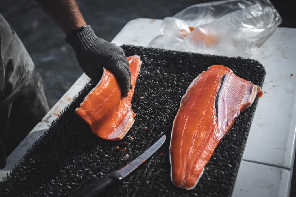 Freshly filleted salmon on a black mat at Kenai River Drifters Lodge.