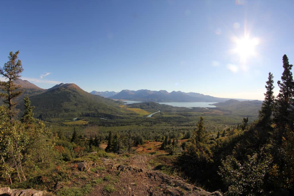 Breathtaking panoramic view of the Kenai River and surrounding mountains in Alaska on a clear sunny day.