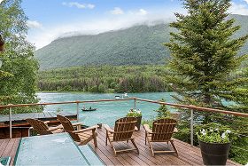 Boat on Kenai River with mountains in background, Alaska.
