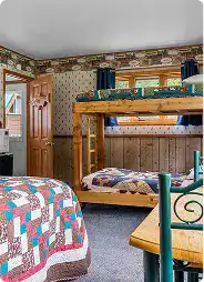 Cozy rustic interior of Kenai River Drifters Lodge with bunk beds and vintage decor.