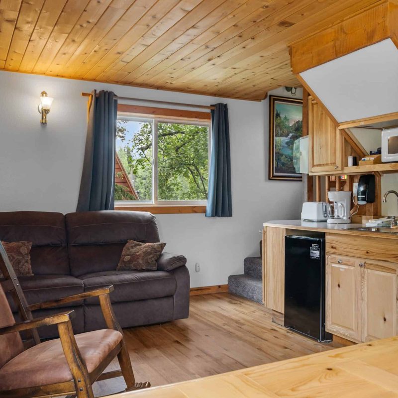 Cozy interior of Kenai River Drifters Lodge with wooden accents and relaxing living space.
