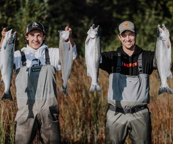 2 clients holding up a limit of silver salmon.