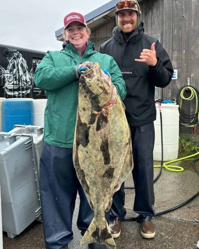 Huge halibut catch at Kenai River Drifters Lodge, Alaska, with smiling anglers showcasing their impressive trophy fish.