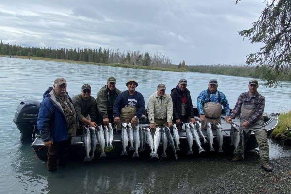 Anglers holding a stringer of the days sockeye salmon catch.